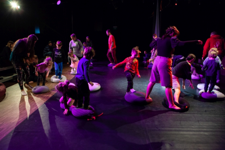 Dzieci odwzorowują zachowanie animatorki na scenie.