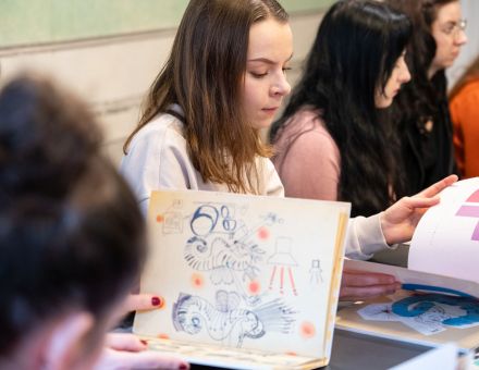 Uczestniczki oglądają książki z ilustracjami. Uczestniczki oglądają książki z ilustracjami.