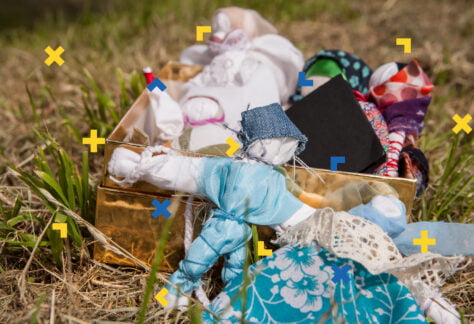 Na trawie leżą lalki motanki.