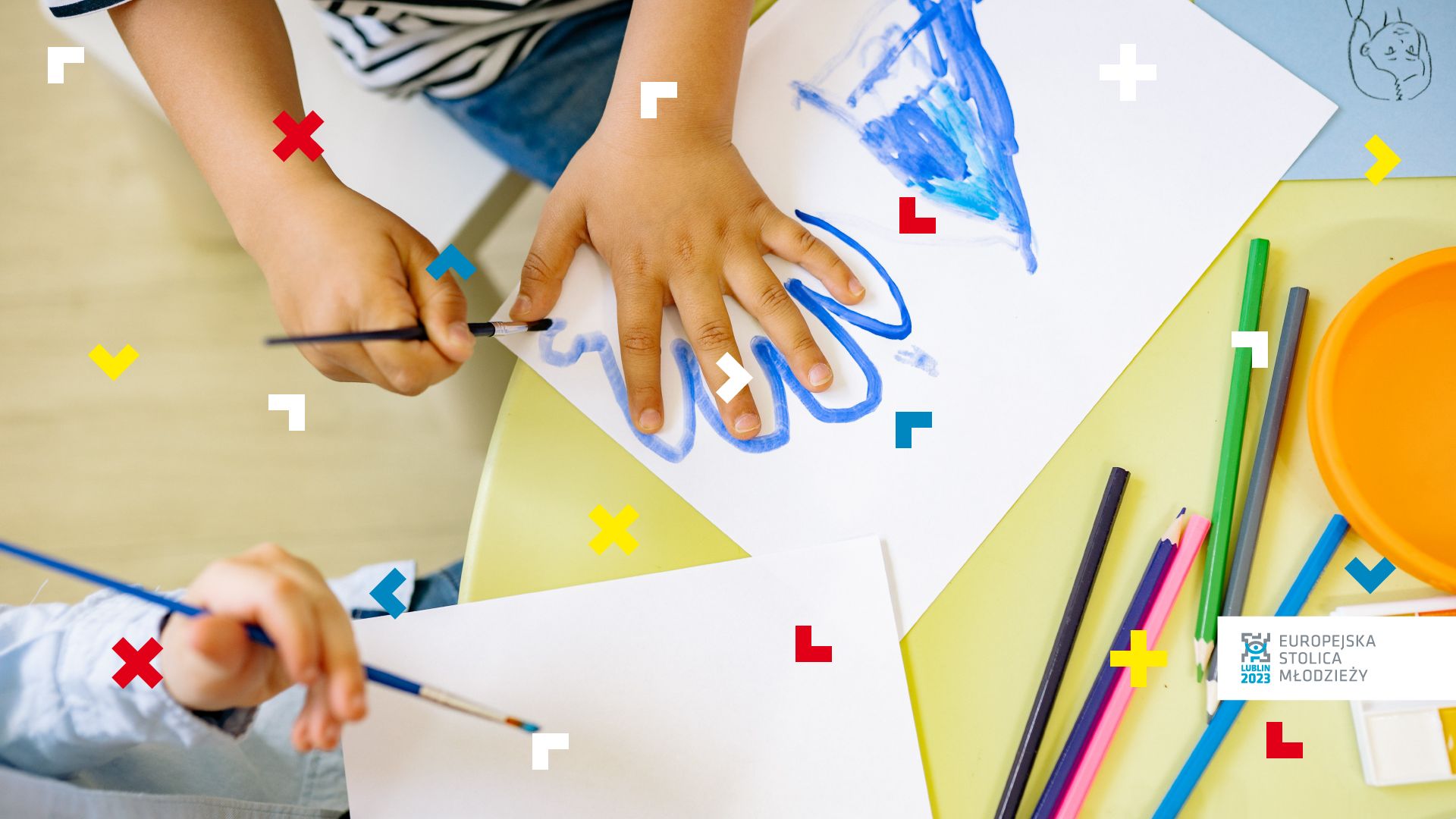 Dzieci malują farbami. Jedno z nich odrysowuje swoją dłoń.