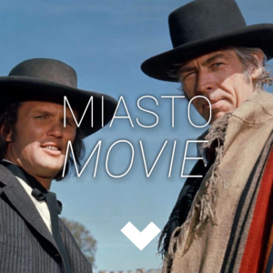 Dwaj mężczyźni w kapeluszach patrzą przed siebie w tym samym kierunku.